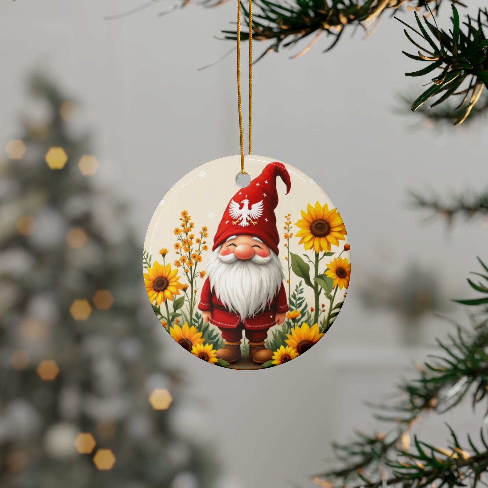 The Polish Gnome Smiling Ceramic Ornaments feature a cheerful red-hatted gnome among sunflowers, hanging from a Christmas tree. This charming keepsake adds festive cheer, with a decorated holiday tree softly glowing in the background.