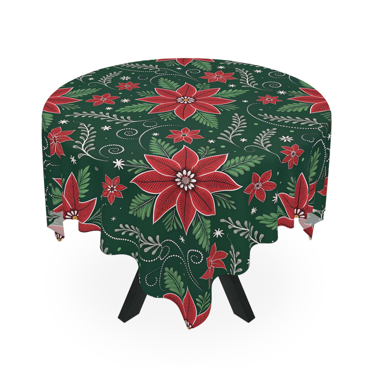 A round table draped with the Christmas Poinsettia Floral Tablecloth, showcasing bold red poinsettia flowers, white highlights, and swirling green leaves. Black legs contrast the white backdrop for a festive touch.