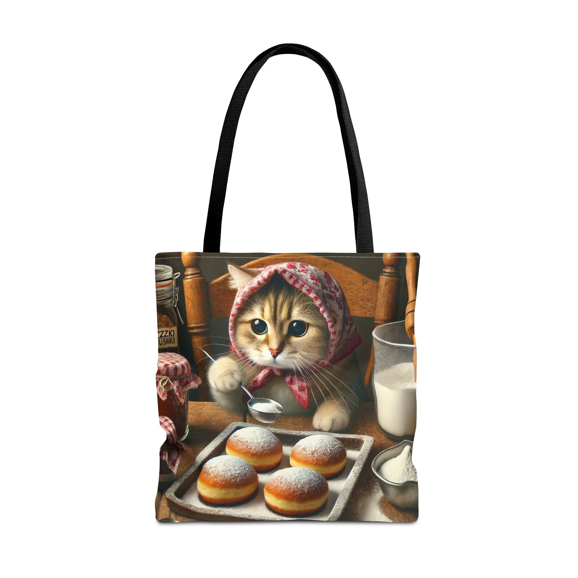 The Cute Polish Cat Making Paczki Tote Bag in Black features a cat in a patterned headscarf enjoying paczki and milk in a cozy kitchen—a delightful and practical gift for cat lovers.