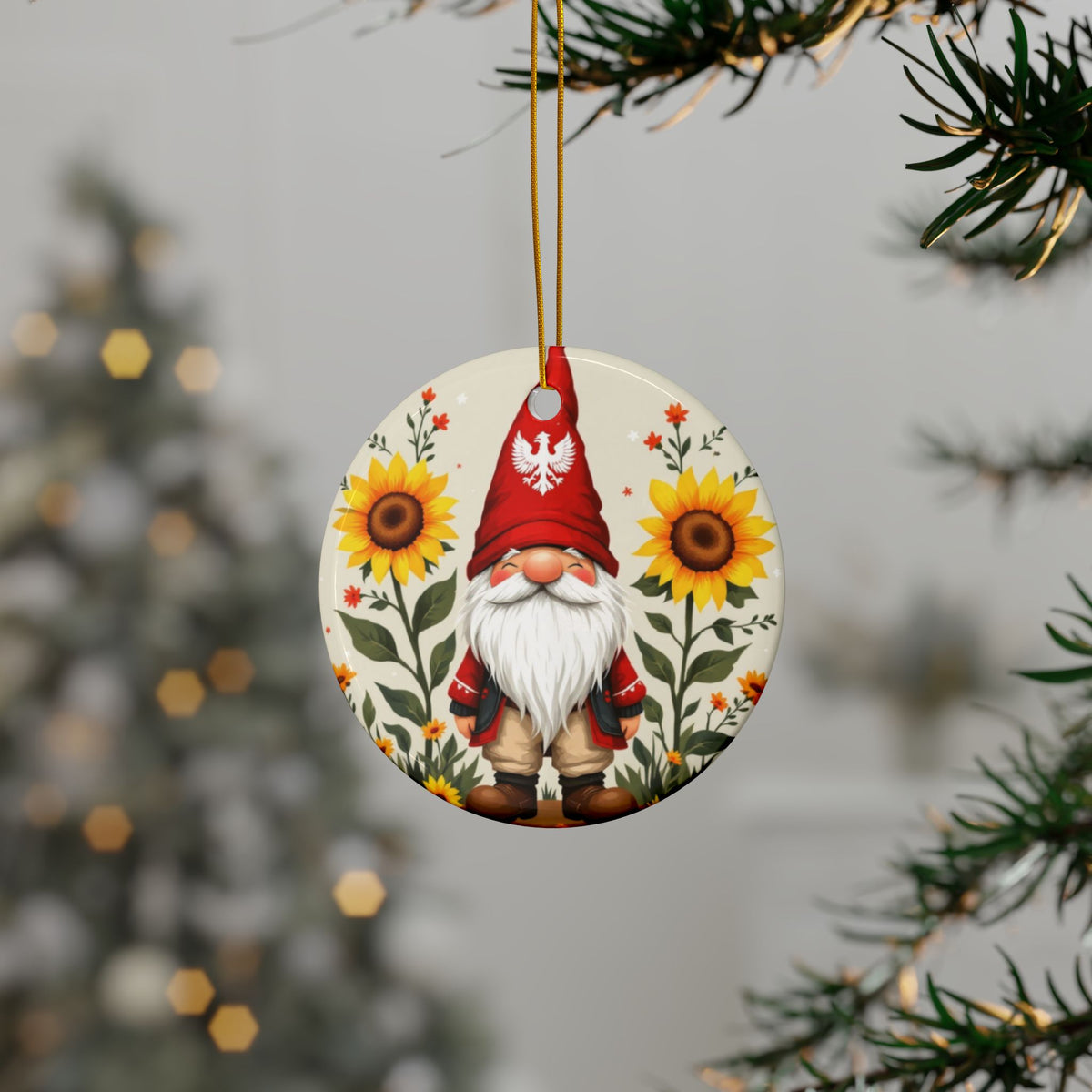 The Poland Gnome Sunflower Ceramic Ornament features a gnome in a red hat with a white eagle emblem standing between two sunflowers. This handcrafted ornament is perfect for decorating your Christmas tree.