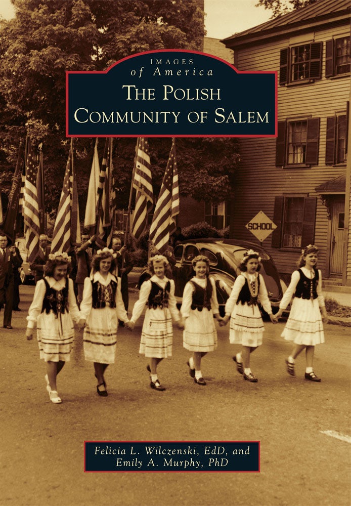 Five girls in traditional Polish dress lead a parade, men with American flags follow—capturing the spirit of Salem’s rich history as depicted in The Polish Community of Salem. Trees and a house frame the lively scene on the street.