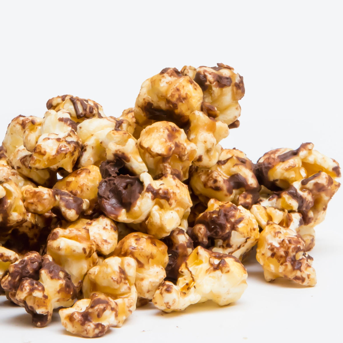 A pile of Chocolate English Toffee Popcorn, drizzled with chocolate, is displayed against a plain white background.