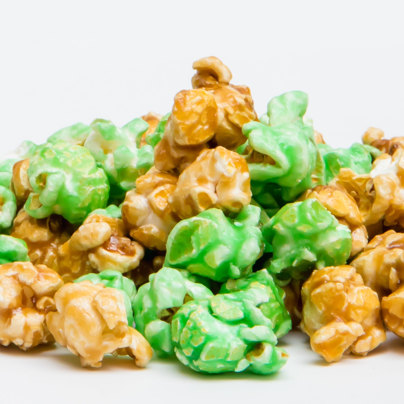 A pile of Caramel Apple Popcorn sits against a plain white background.