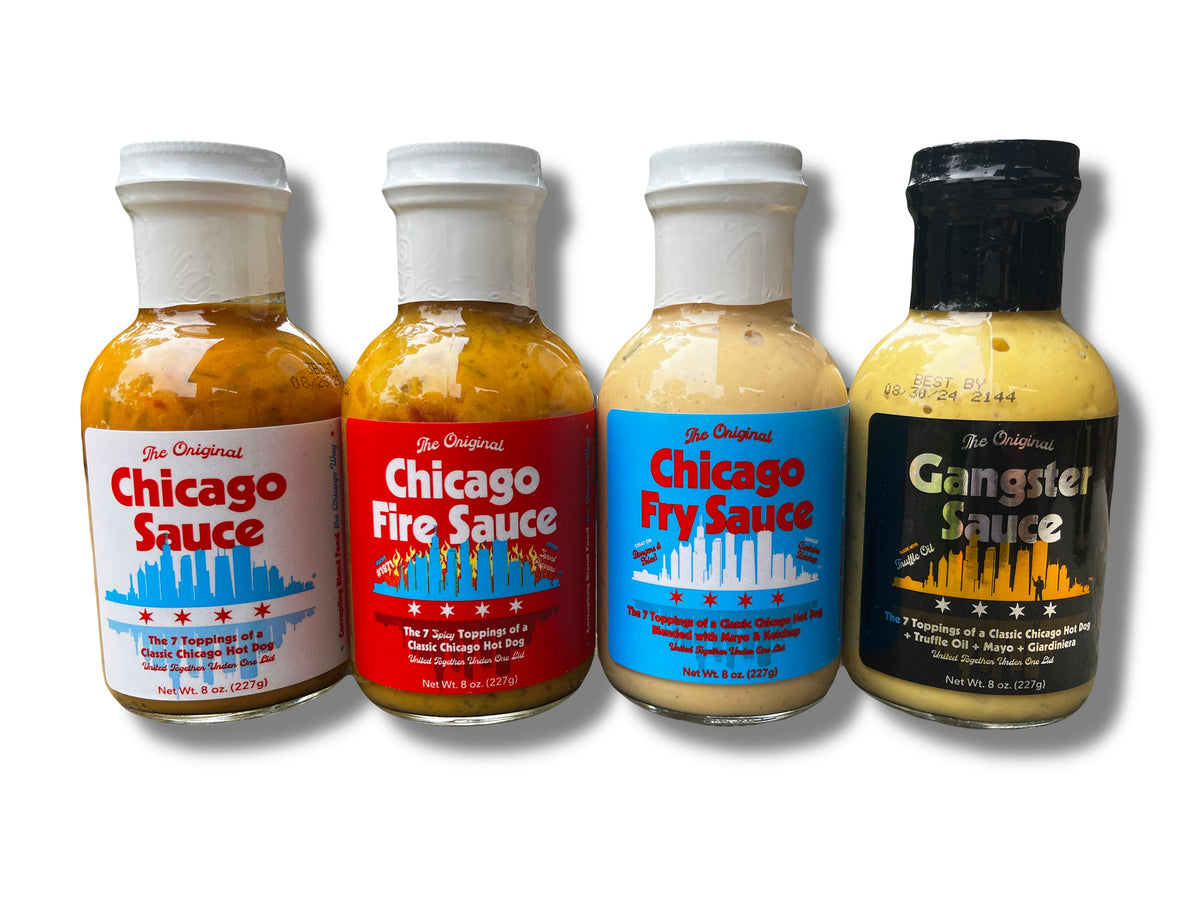 Four bottles—Chicago Sauce, Chicago Fire Sauce, Chicago Fry Sauce &amp; Gangster Sauce—stand side by side, each with a vibrant cityscape label. A flavorful lineup for classic Chicago hot dog sauce fans.