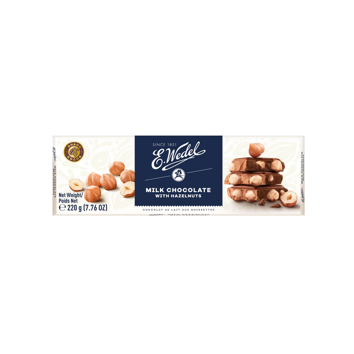A Wedel Luksusowa Chocolate W/ Hazel 220g wrapper shows whole hazelnuts and stacked milk chocolate with hazelnuts, labeled &quot;Milk Chocolate with Hazelnuts&quot; and weighing 220g (7.76 oz).