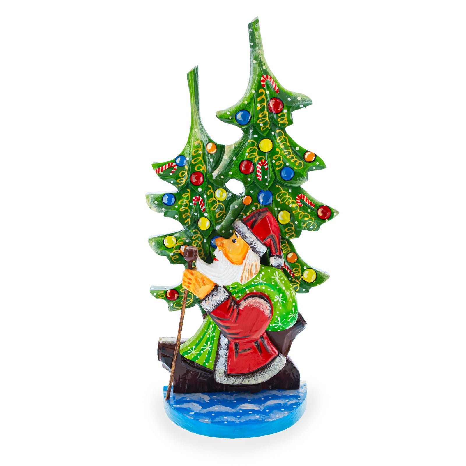 The Did Moroz (Santa) and Christmas Tree Hand Carved Ukrainian Wooden Figurine, 12.25 inches tall, features Santa in red and green canoeing on blue water with two festive trees behind him, adorned with ornaments and garlands. Made in Ukraine.