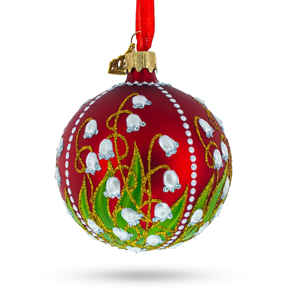 The 1898 Lilies of the Valley Royal Glass Ball Christmas Ornament (3.25 inches) features hand-painted white flowers, green leaves, and gold accents on red glass, hanging from a red ribbon—ideal for festive holiday décor.